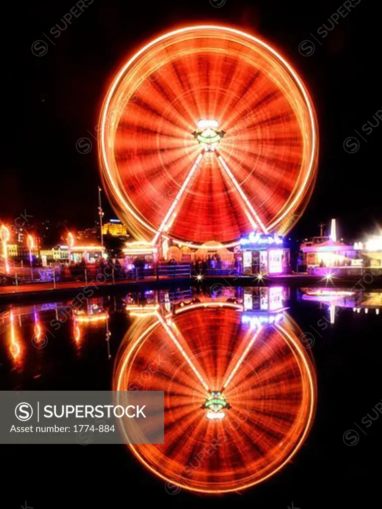 Reflection of a lit up ferris wheel, Europaplatz, Lucerne, Switzerland