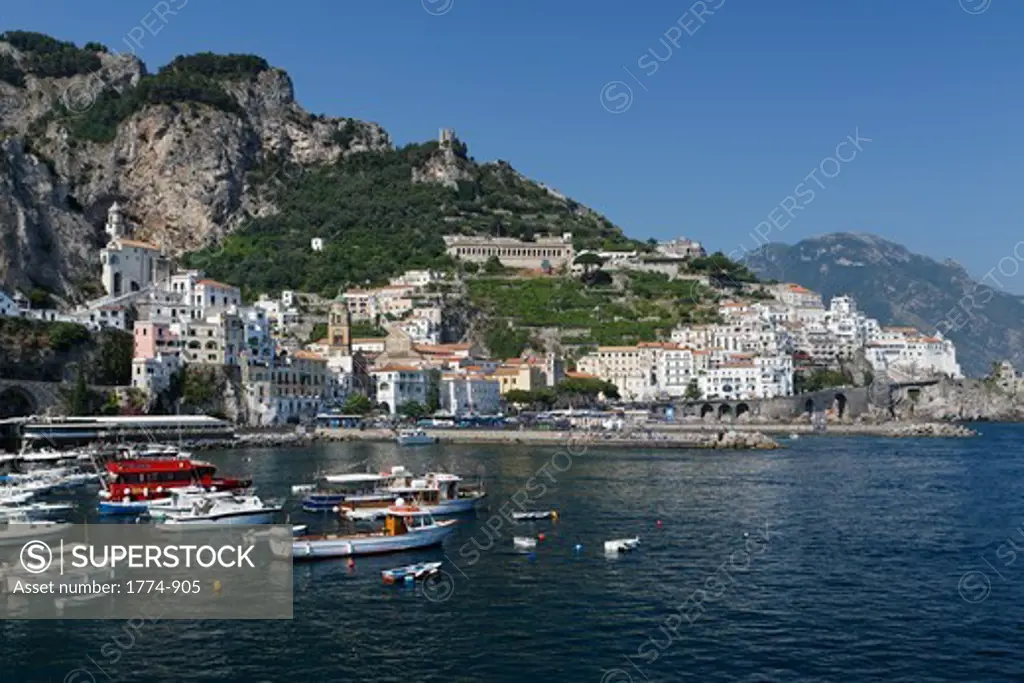 Boats at a harbor with town in the background, Amalfi, Campania, Italy