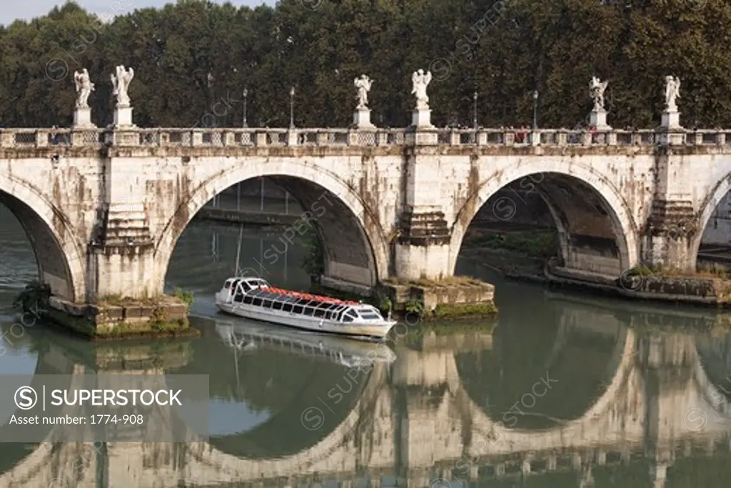 Riverboat passing under a bridge over a river, Ponte Sant'Angelo, Tiber River, Rome, Lazio, Italy