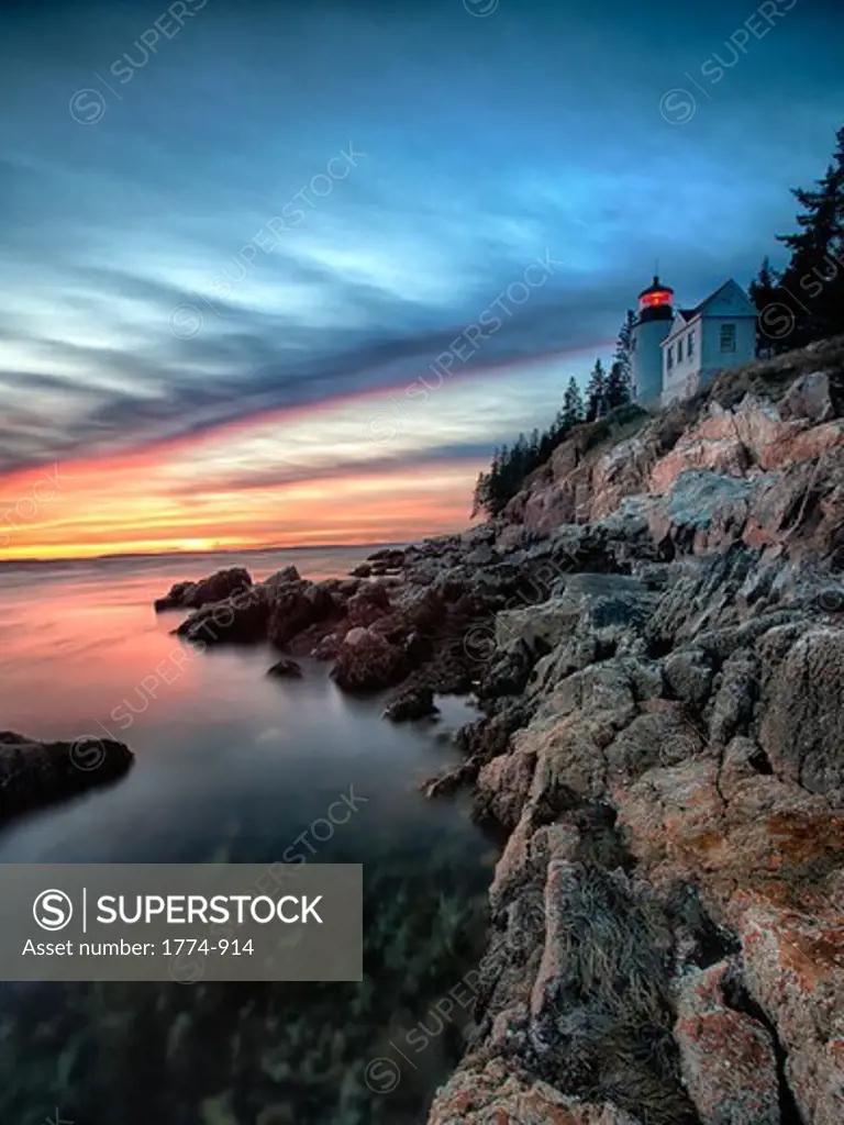 Lighthouse on the coast at sunset, Bass Harbor Head Lighthouse, Acadia National Park, Mount Desert Island, Maine, USA