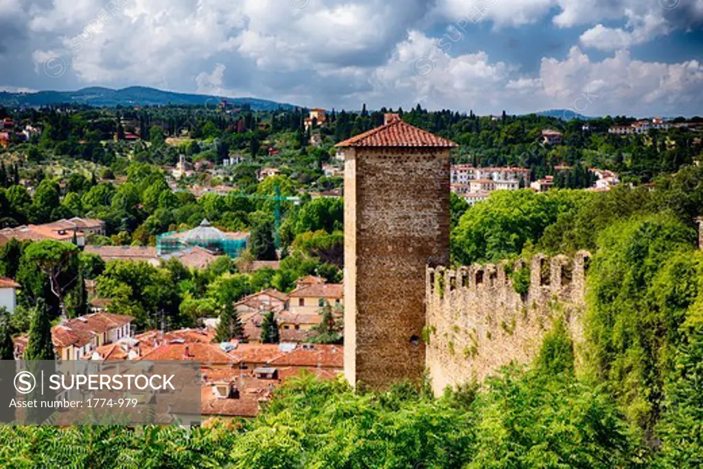 Italy, Tuscany, Florence, View of medieval city wall and tower on hill