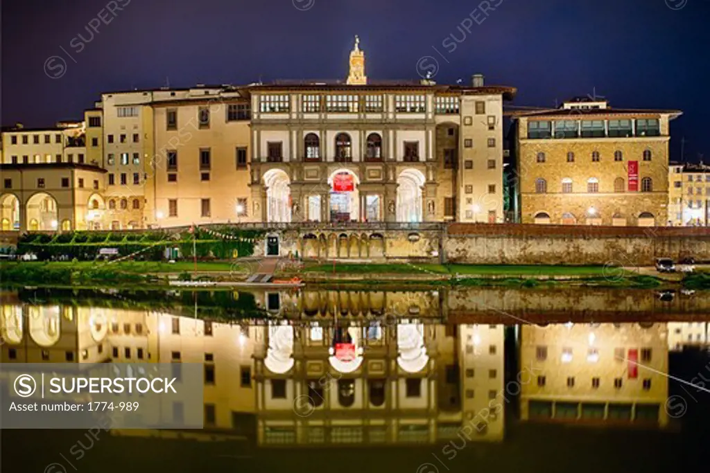 Italy, Tuscany, Florence, Night reflection of Uffizi Gallery in Arno River