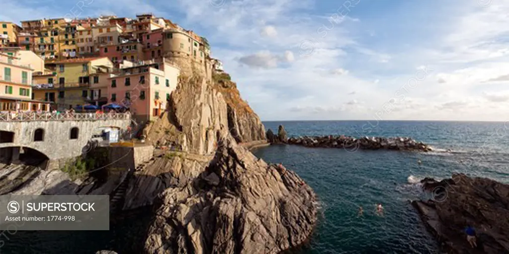 Italy, Liguria, Manarola, Cinque Terre, harbor view of town on cliff