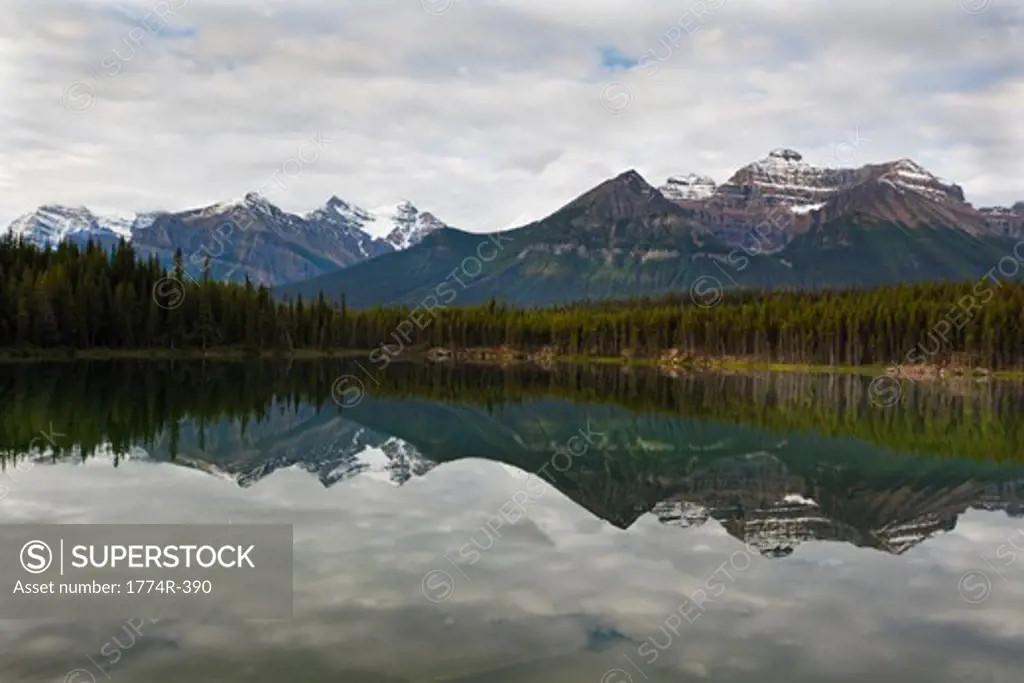 Reflection of clouds and mountains in a lake, Lake Herbert, Banff National Park, Alberta, Canada