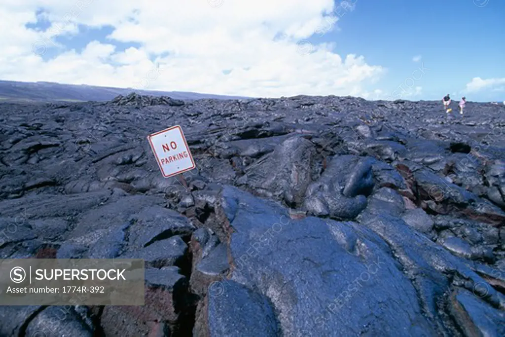 No Parking' Sign buried by a lava flow, Hawaii Volcanoes National Park, Big Island, Hawaii, USA