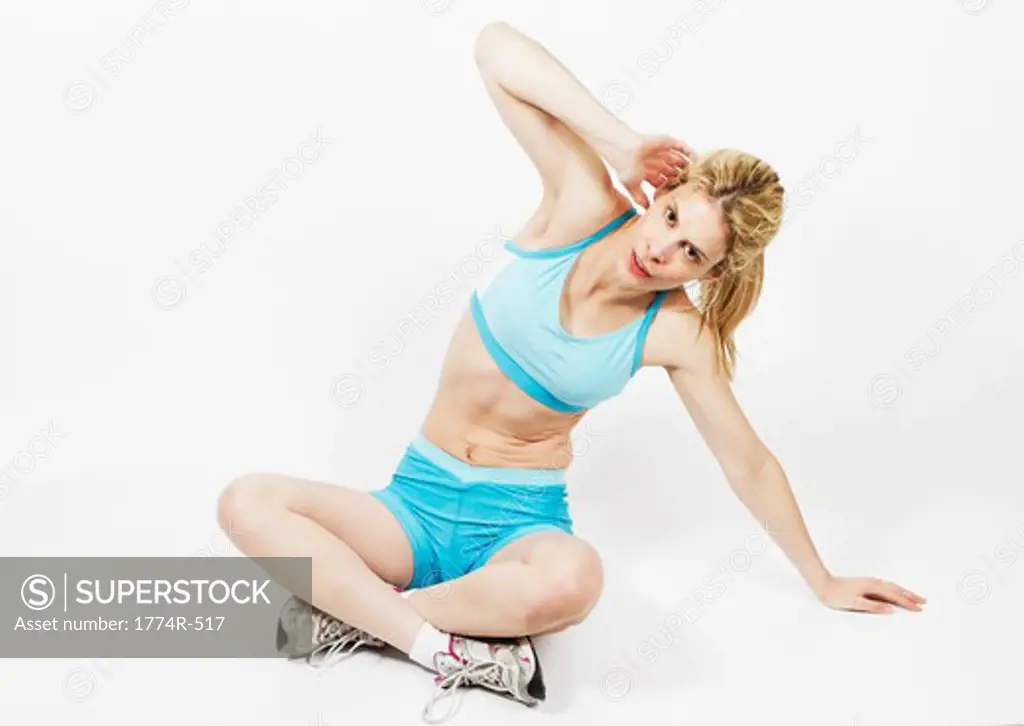 Woman sitting on the floor and exercising