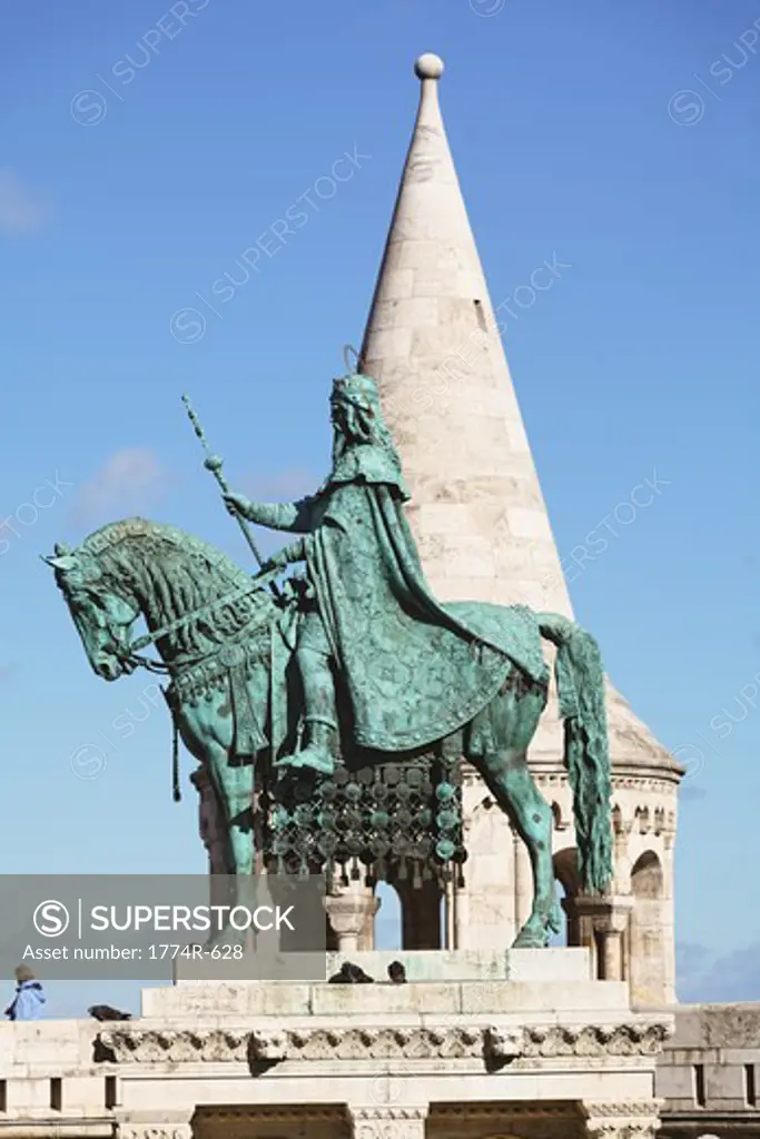 Hungary, Budapest, Equestrian statue of St Stephens First King of Hungary with tower of Fishermen's Bastion in background
