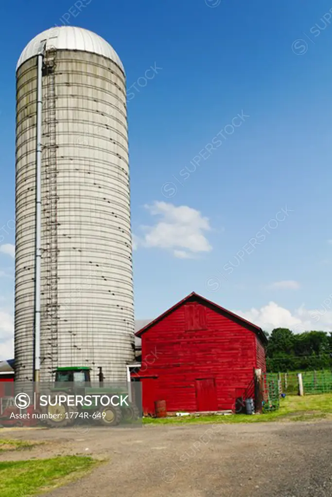USA, New Jersey, Hunterdon County, Tractor parked in front of silo and barn at farm