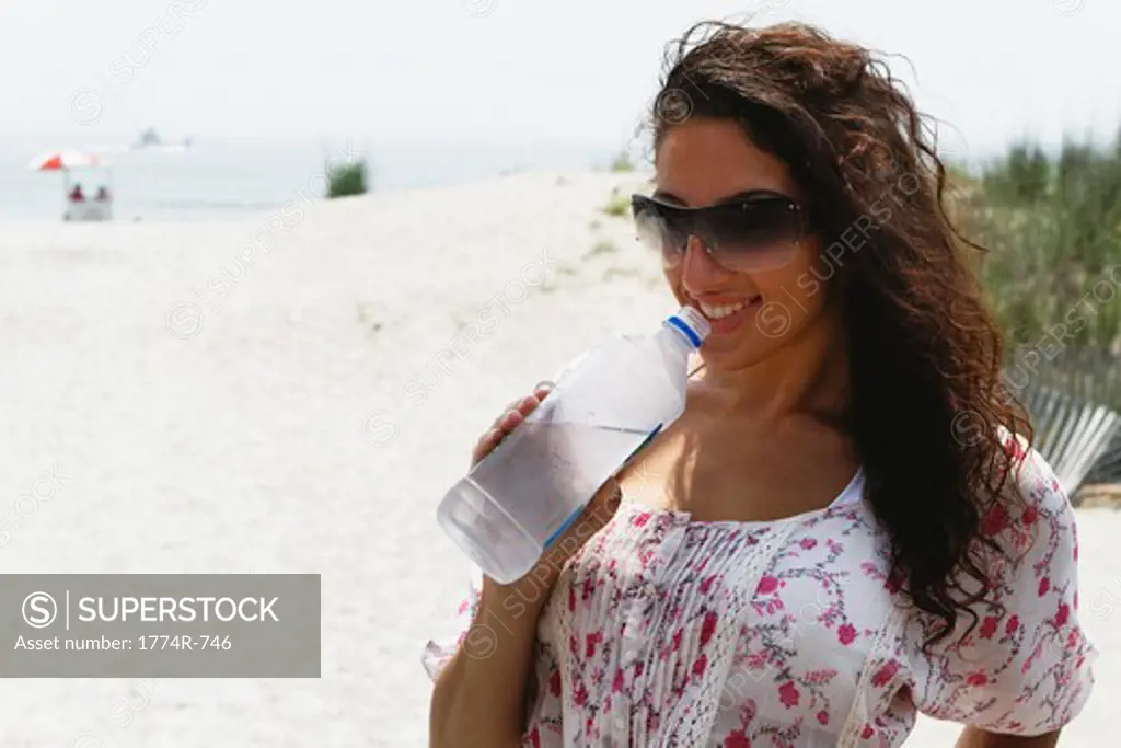 USA, New Jersey, Ocean City, Close Up View of Woman Drinking Bottled Water on Beach