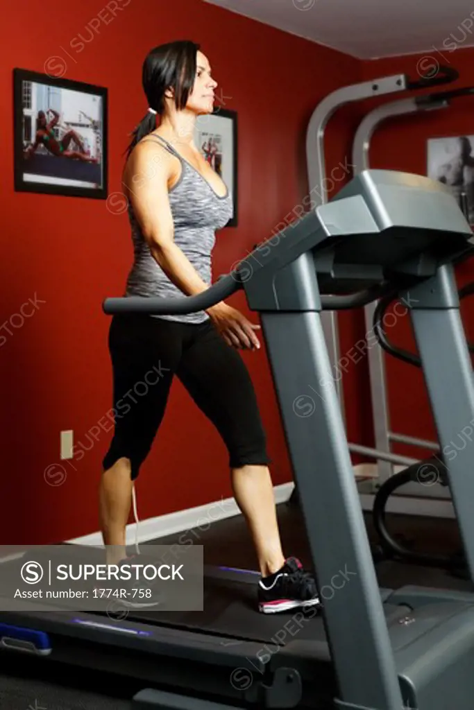 USA, New Jersey, Low Angle View of Fit Mid Adult Woman Exercising on Treadmill