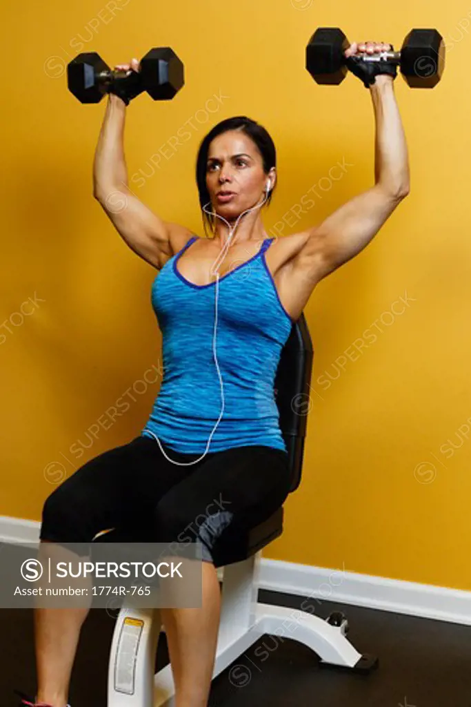 USA, New Jersey, Fit Mid Adult Woman Exercising with Dumbells