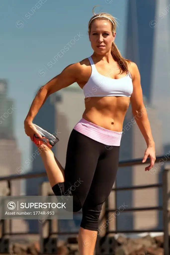 USA, New Jersey, Jersey City, Woman stretching in park