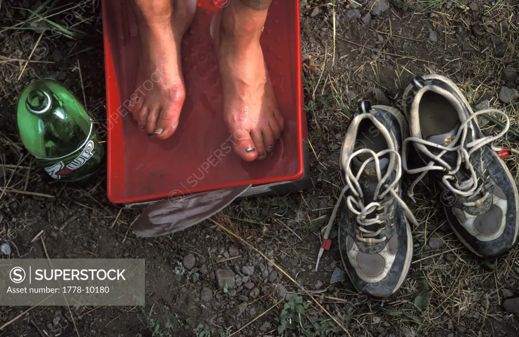 A sore pair of feet rest in a footbath after the trekking leg of an adventure race