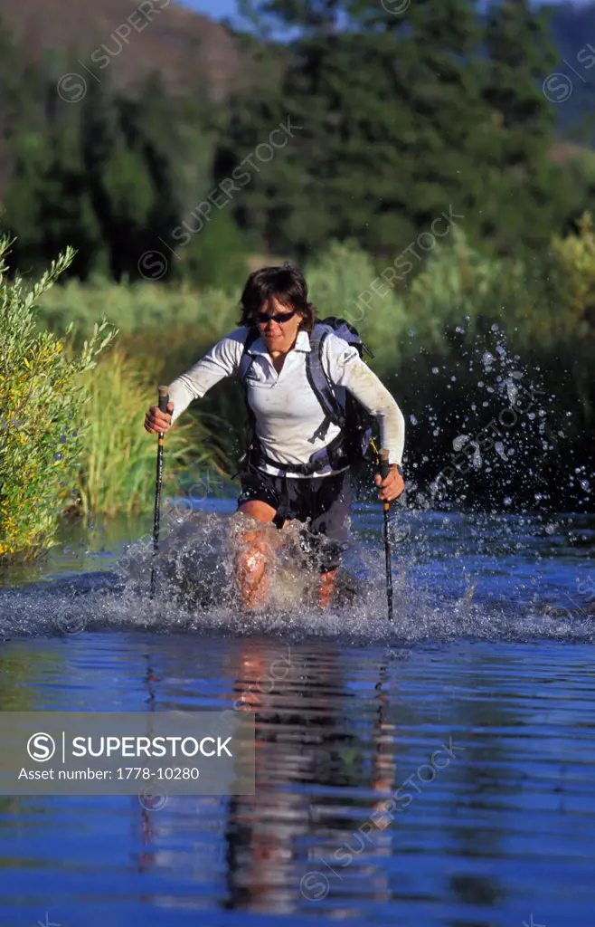 A female competitor powers downriver during an adventure race