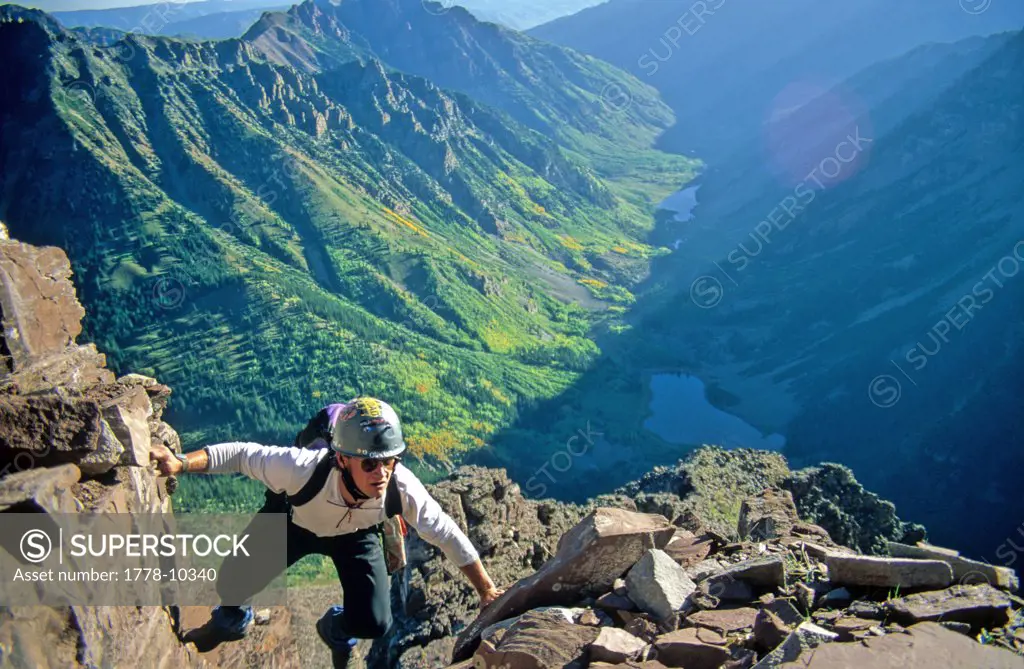 A man climbs to the summit of Maroon Peak near Aspen Colorado