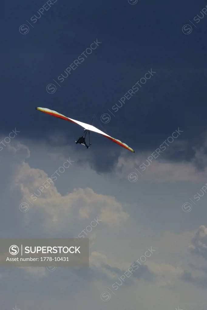 Female hang glider pilot highlighted against  dark stormclouds at the Lookout Mountain Flight Park near Chattanooga, TN
