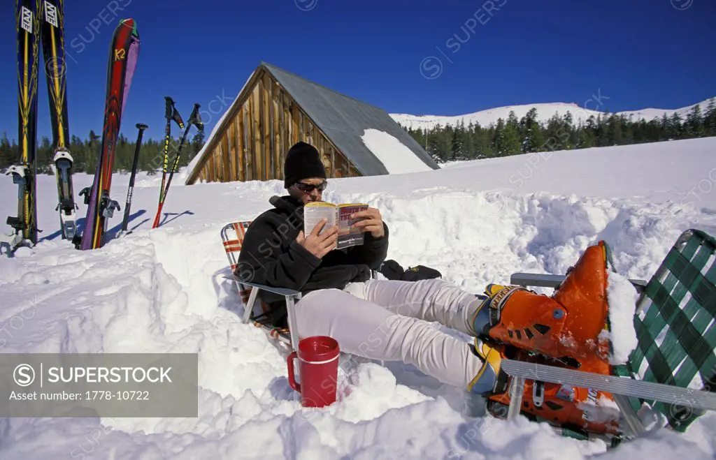 A  man relaxing in the snow in the backcountry