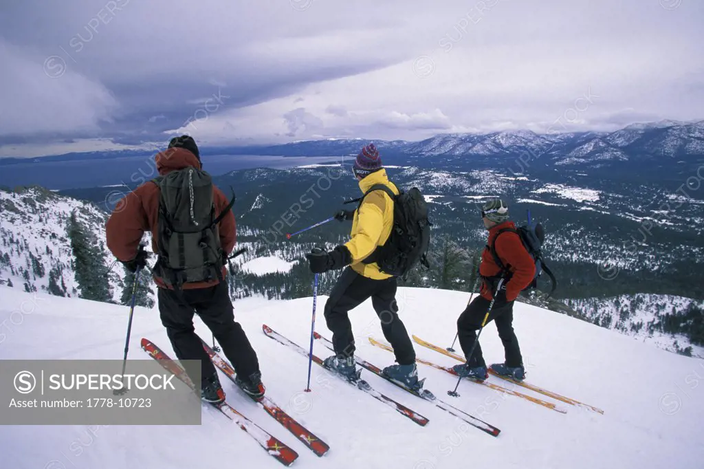 Three men getting ready to ski in the backcountry