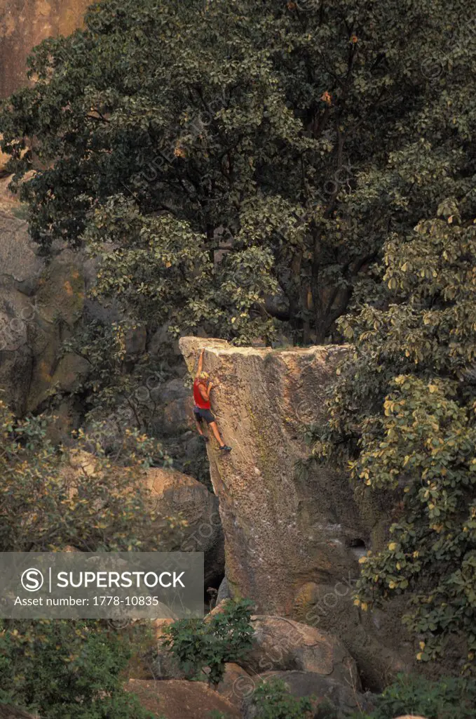 A male rock climber climbing a dificult bouldering route