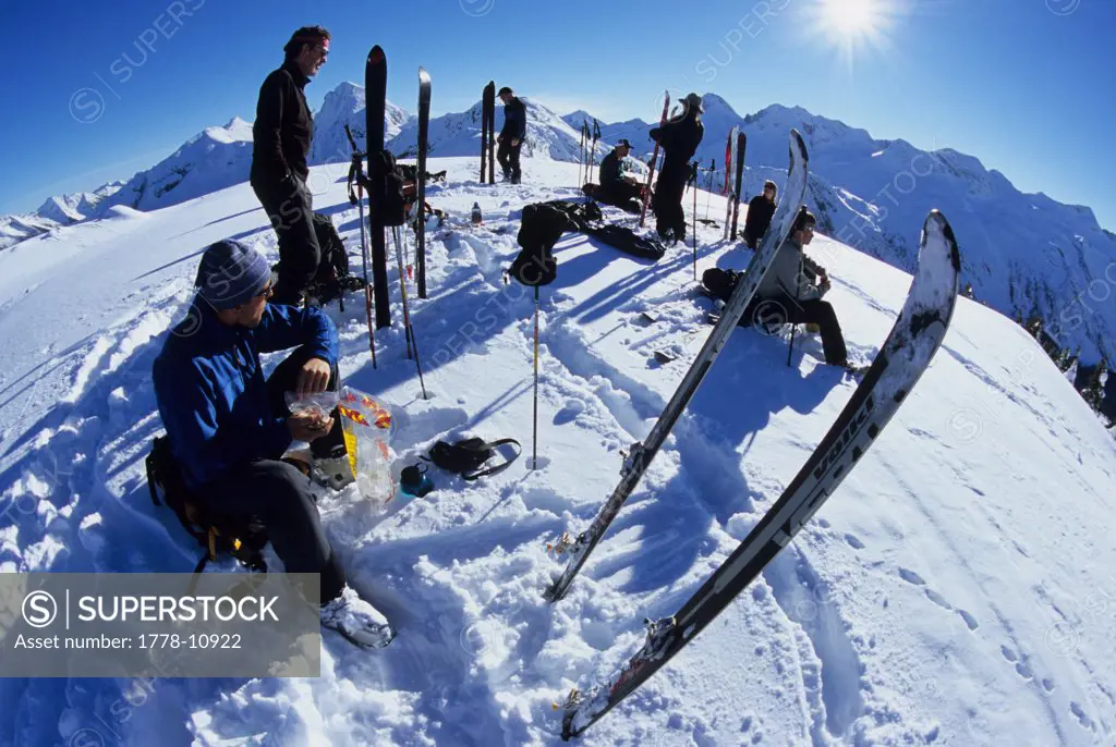 Skiers rest on a ridgetop in the Powder Creek Basin, near Kooteney Lake, Nelson, British Columbia