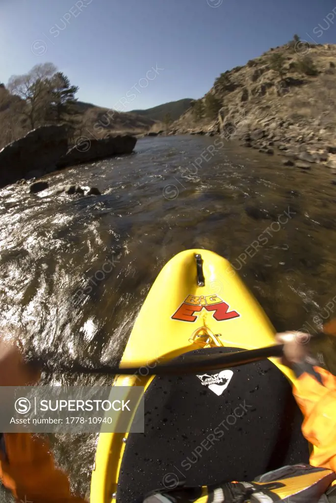 A kayaker's perspective paddling on the Cache La Poudre River near Fort Collins, Colorado