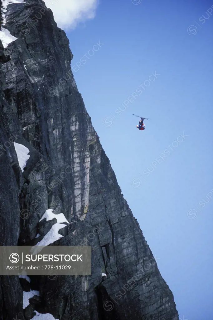Ski-BASE jumper doing a front flip off a cliff near Lake Tahoe