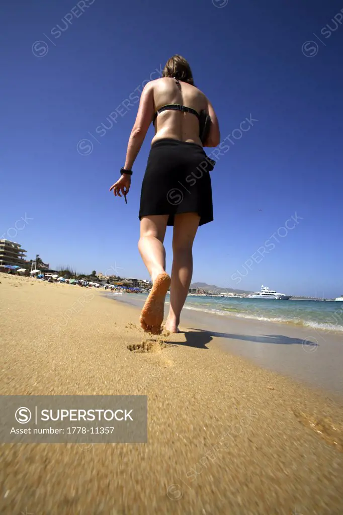 Amy Herron walks on Medano Beach in Cabo San Lucas in Baja, Mexico