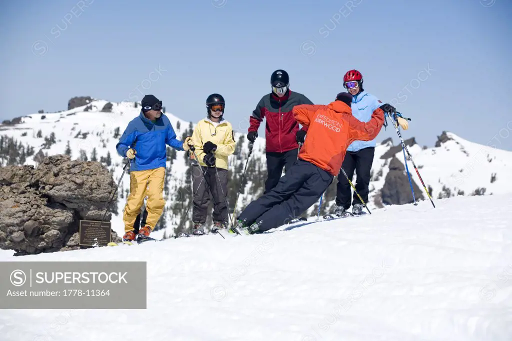 Ski instructor goofing around while giving lesson to group at Kirkwood ski resort near Lake Tahoe, CA