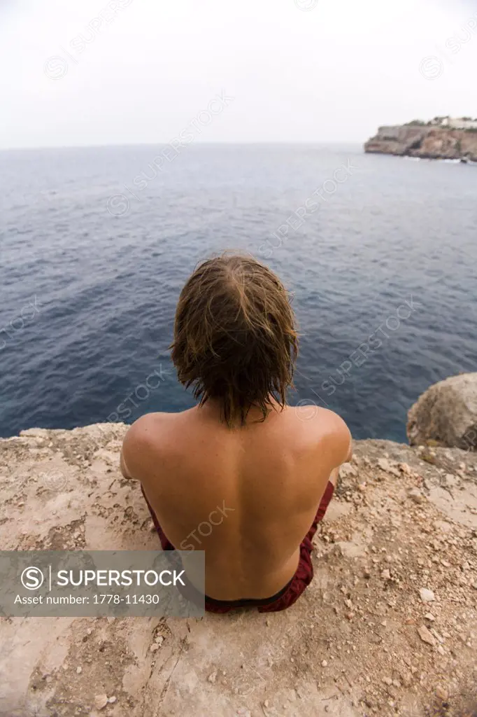 Chris Sharma relaxing and meditating before attempting to rock climb his deep water soloing project The Arch or Es Pontas