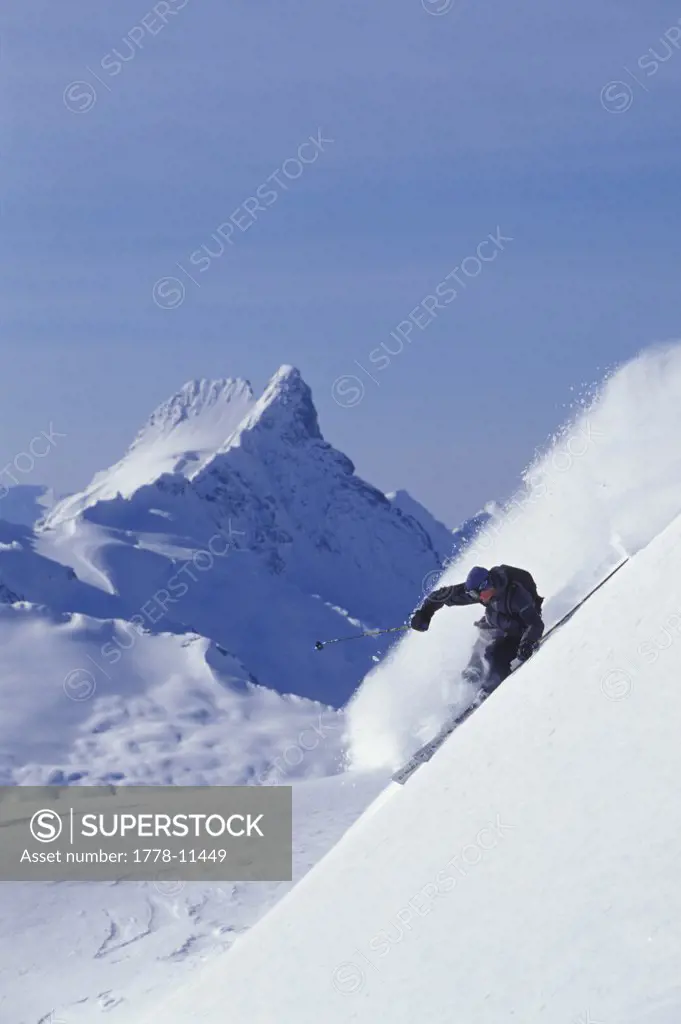 Male skier (Ryan Oakden) skiing steep line at Mica Heliskiing near Mica Creek, BC, Canada