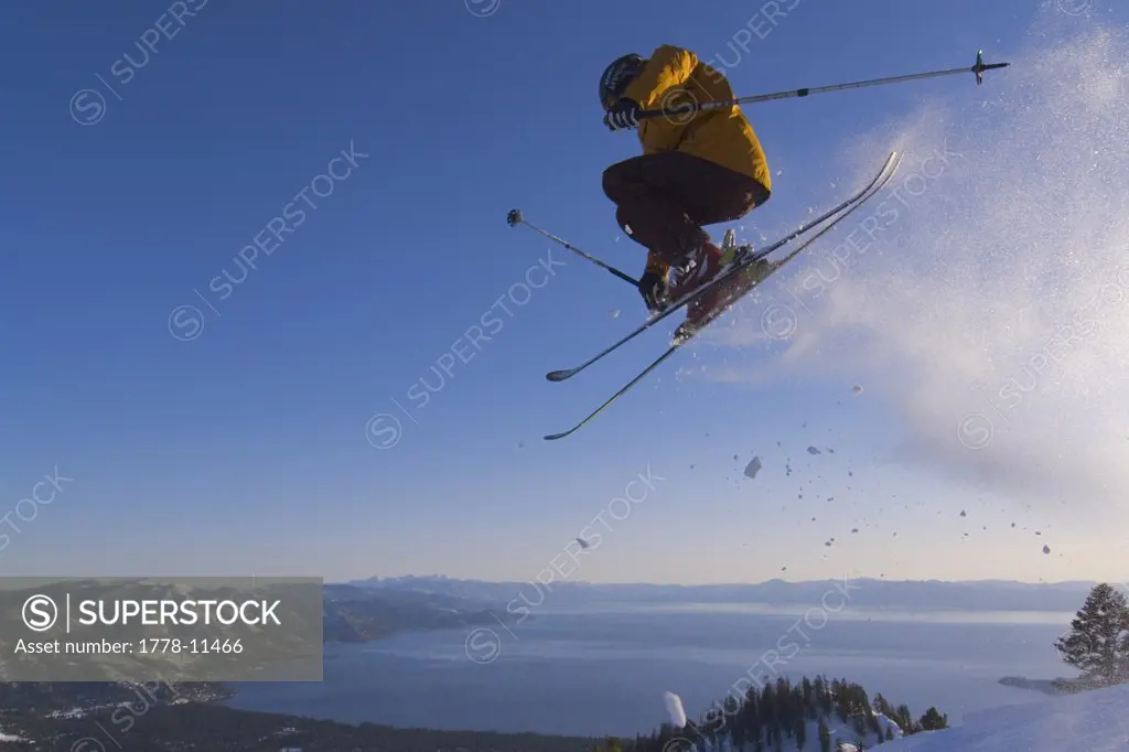 A man jumping on skis above Lake Tahoe in California