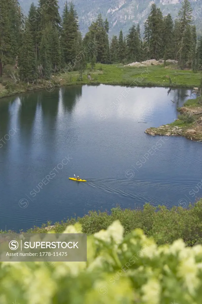 A Man Kayaking on a Mountain Lake in California