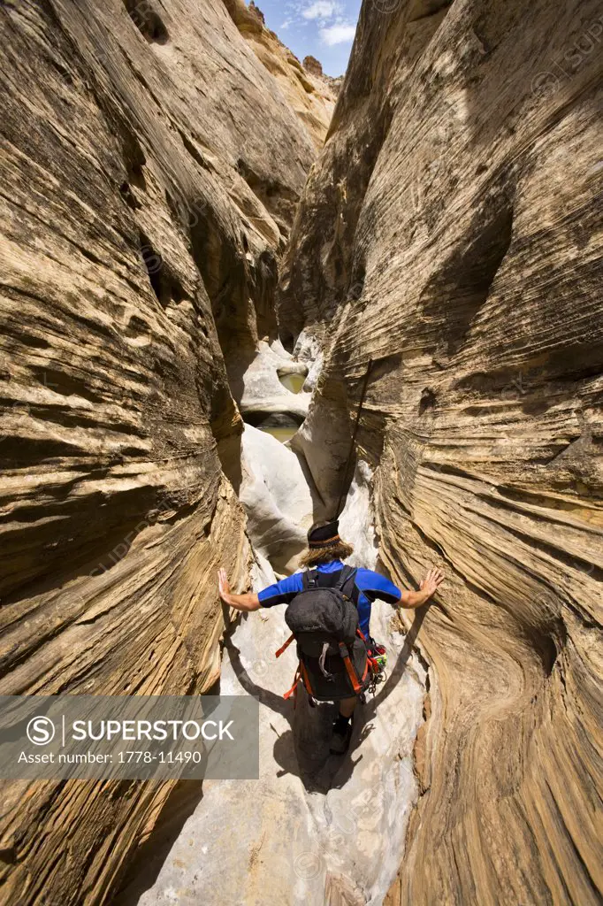 man descending desert canyon, San Rafael Swell, Utah