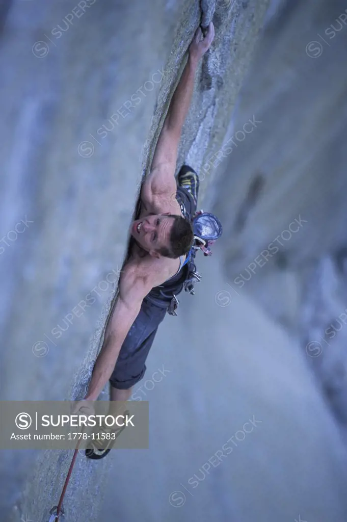 A man rock climbing on a big wall
