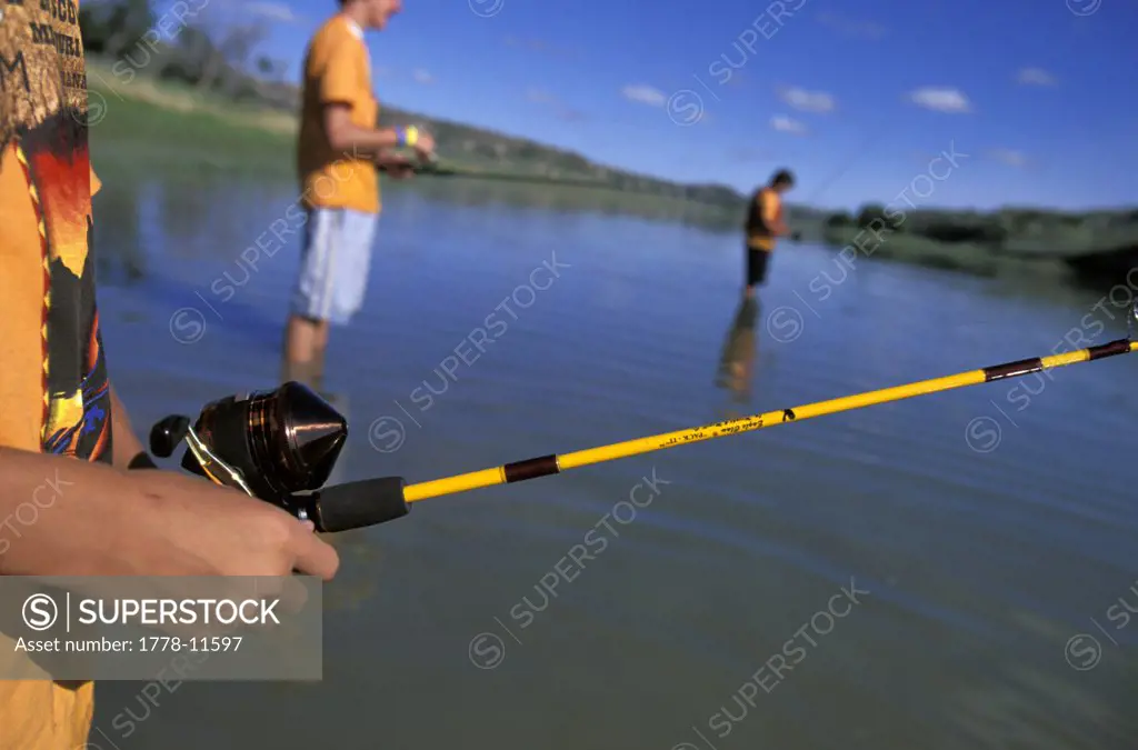 Boys Fishing in a river on a sunny day