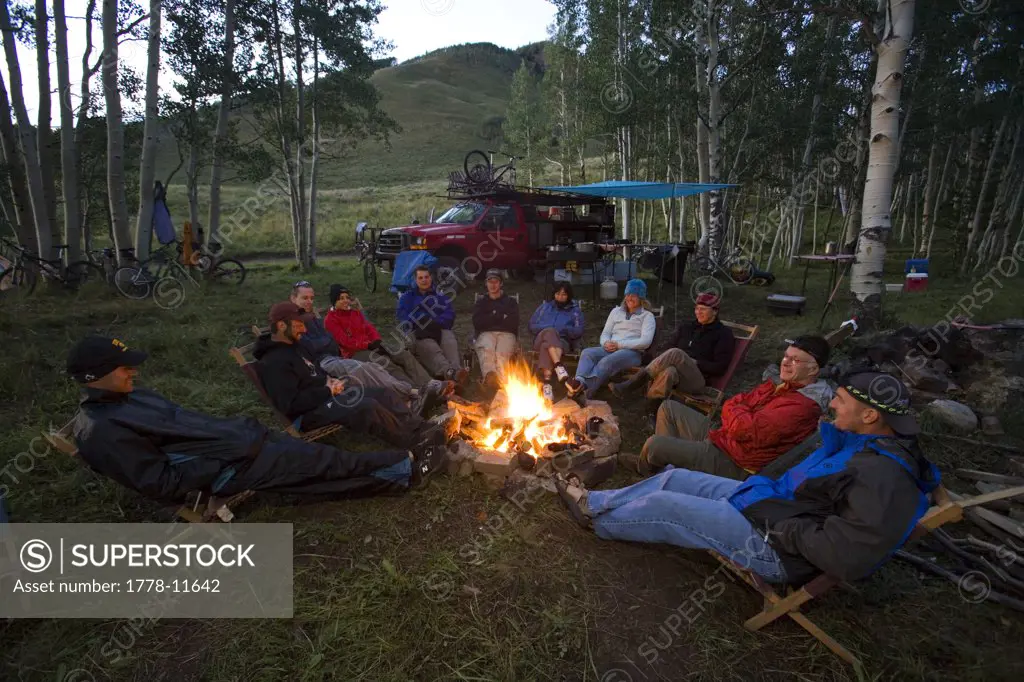 Group sitting around campfire, Colorado