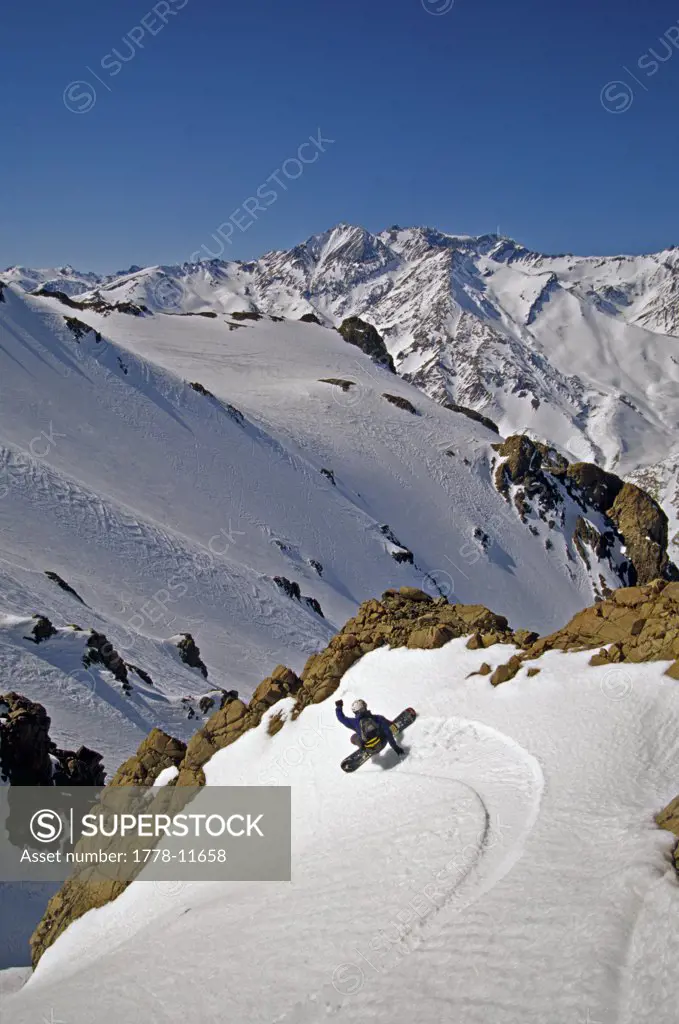 person snow boarding carving turn, Argentina