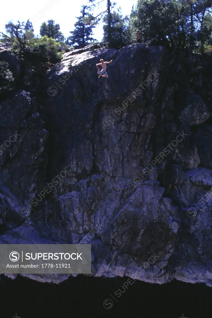 A man cliff jumping into water on the South Yuba River, CA