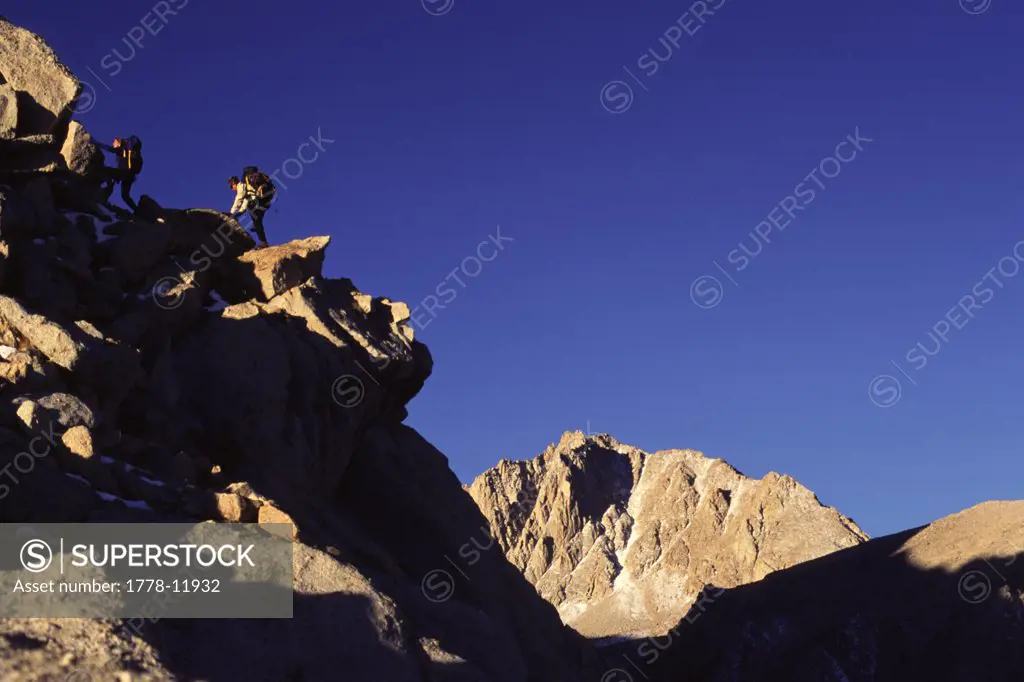 Two people hiking up rocks at Lone Pine Peak in California