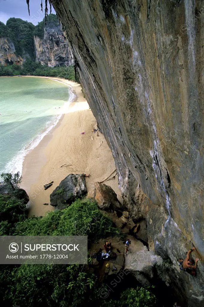 A man climbs above the ocean in Thailand
