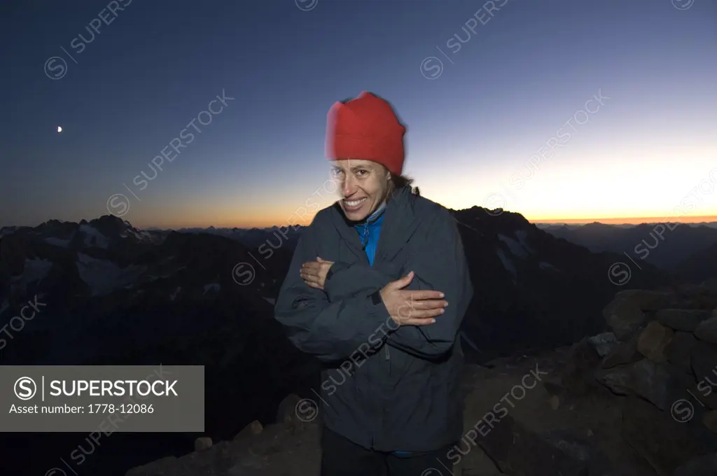 Portrait of woman shivering at dusk at mountain bivouac