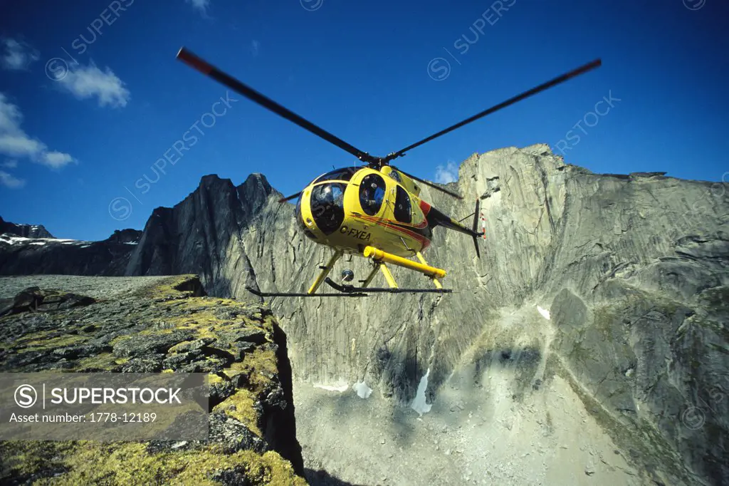 The Inconnu Lodge's Hughes 500 helicopter lands on Terrace Tower above Fairy Meadows in the Cirque of the Unclimbables in the No