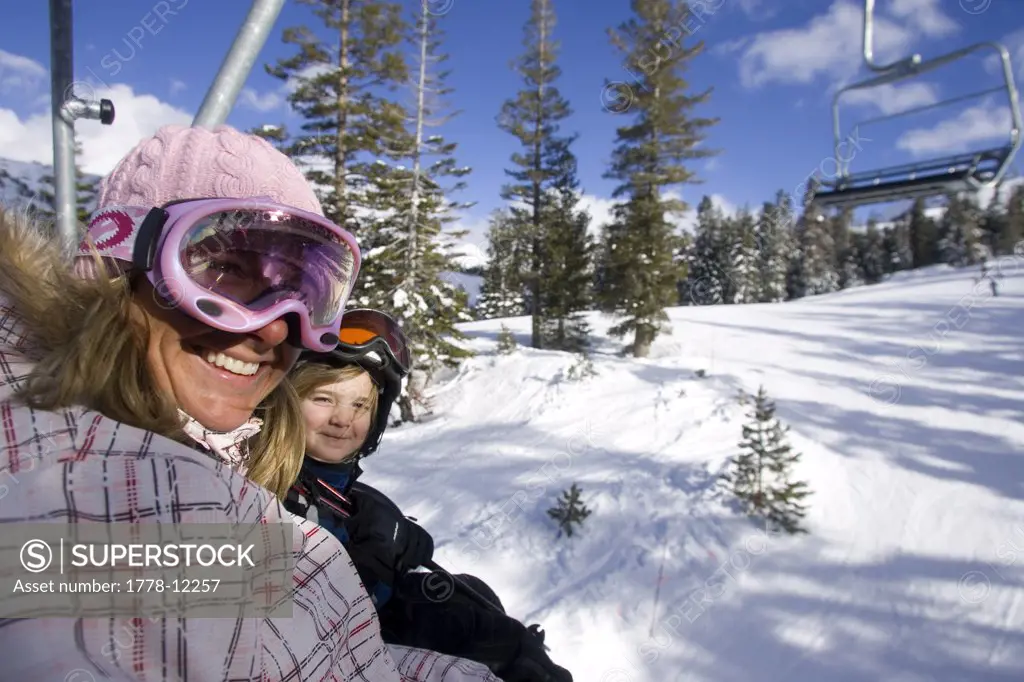 Young woman and child  riding chairlift  at Kirkwood, California