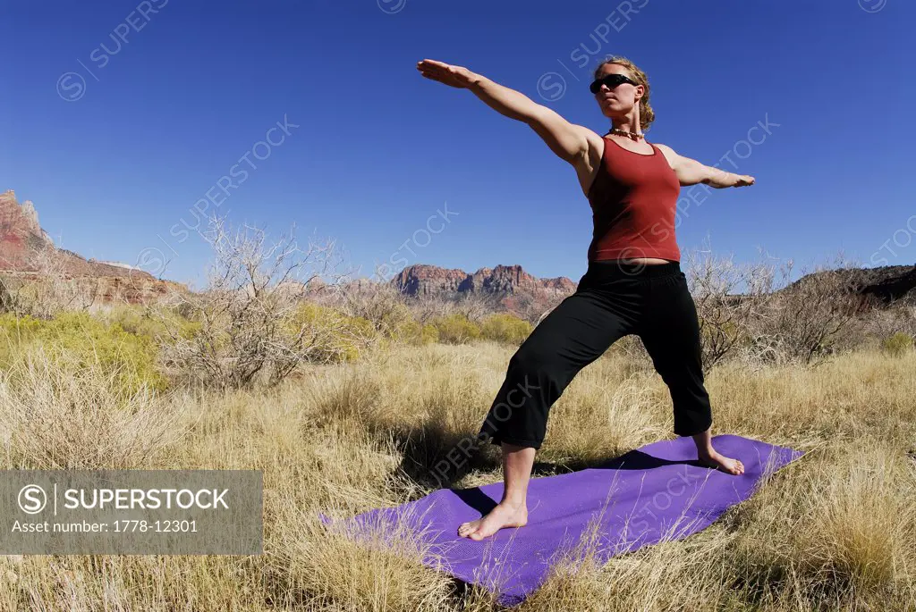 A woman doing yoga outside in Springdale, Utah