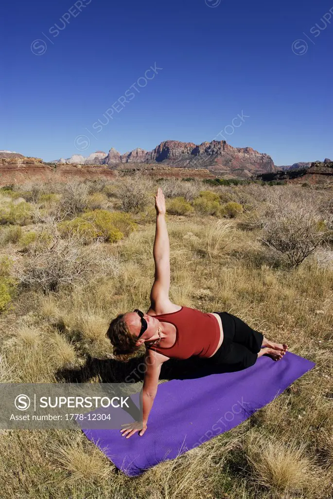 A woman doing yoga outside in Springdale, Utah
