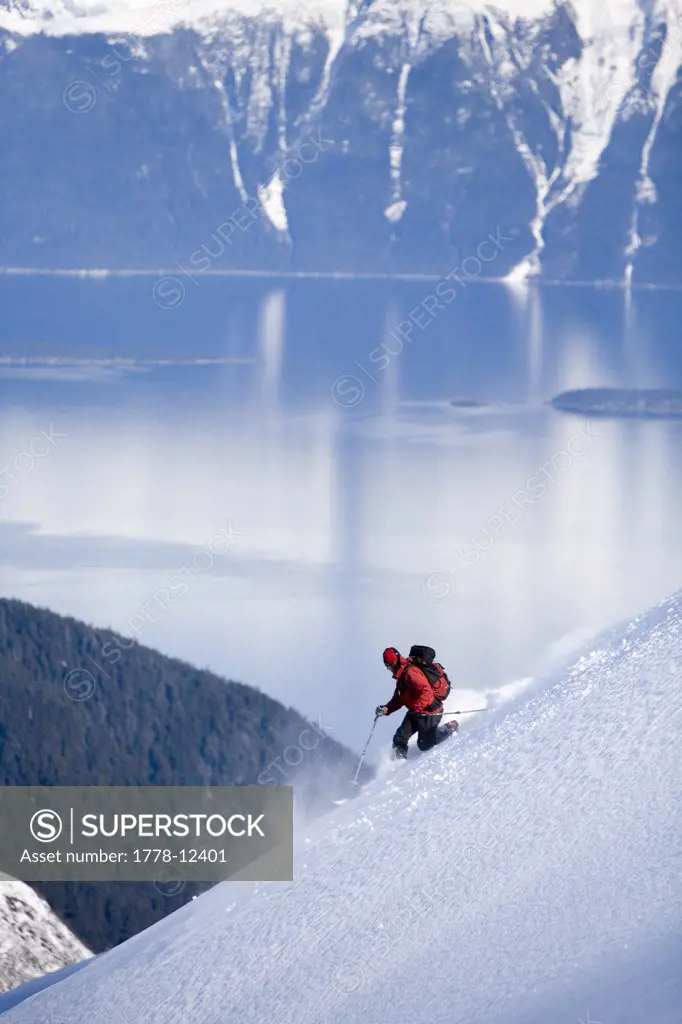 Telemark skier descends steep mountain in backcountry of southeast Alaska