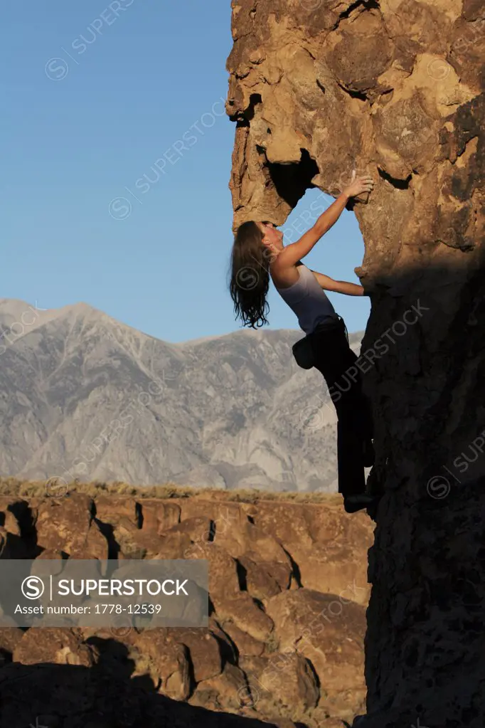 Woman rock climbing, Bishop, California