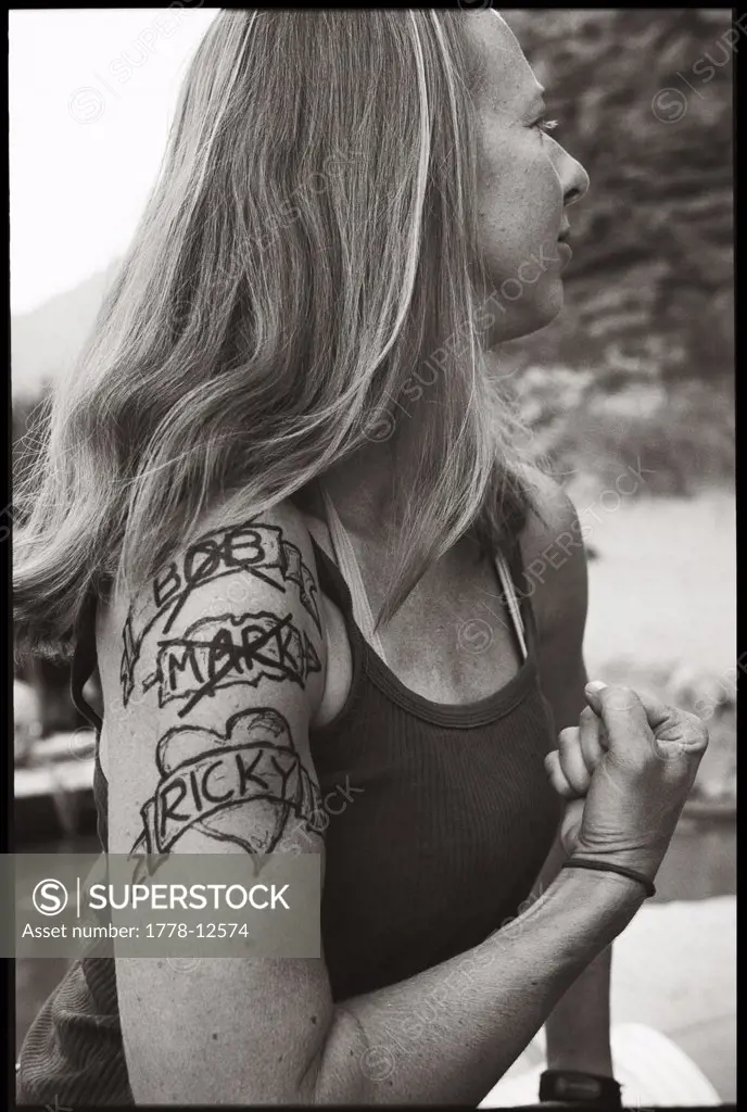 A young female river guide shows off her magic marker tattoos on a whitewater rafting trip through Grand Canyon National Park, A