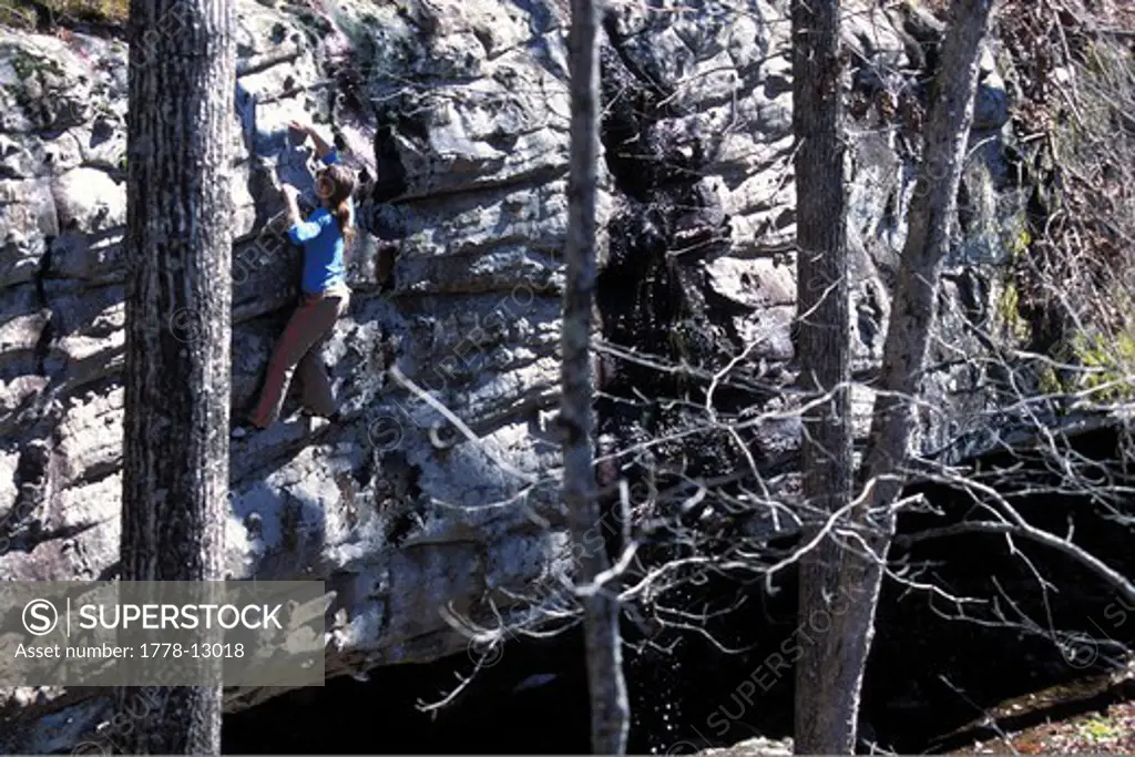 A female climber bouldering near Jasper, Arkansas