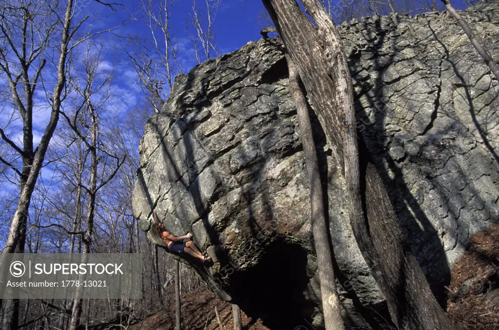 Male rock climber bouldering without a shirt near Jasper, Arkansas